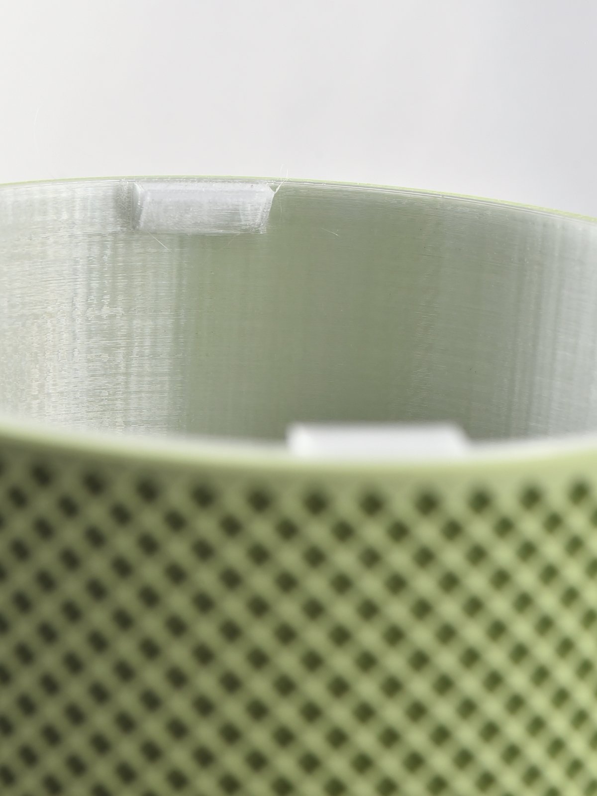 Looking into an EverGrow cachepot at the built-in handles on the rim of the clear inner planter