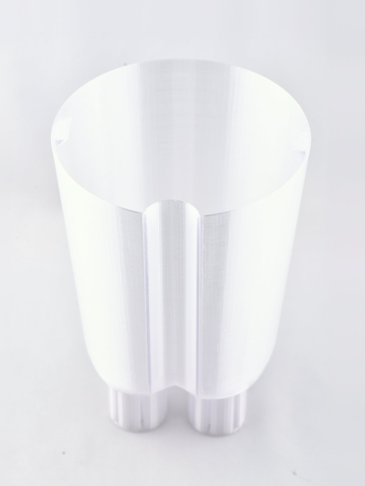 The clear EverGrow inner planter on its own, with the water tunnel running down its side to the reservoir at the base