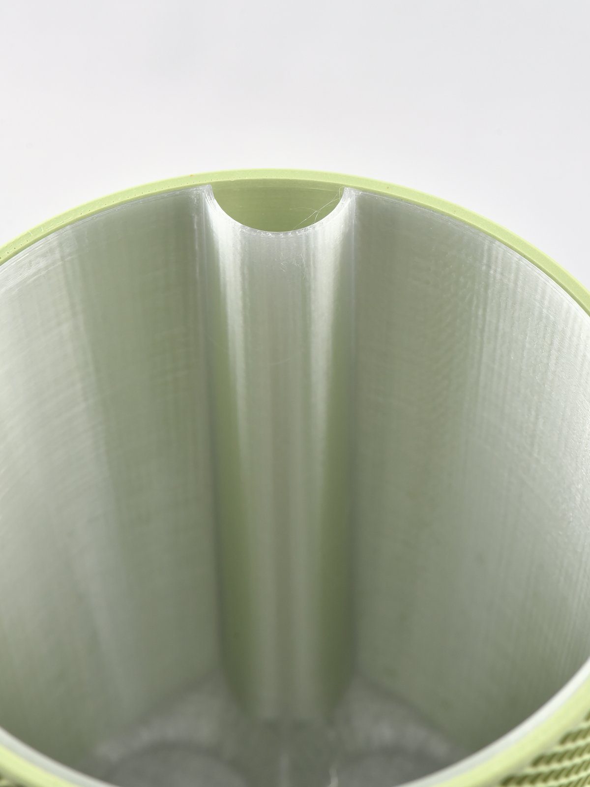 Looking down into a Sage Green EverGrow cachepot at the water tunnel running down the side of the inner planter
